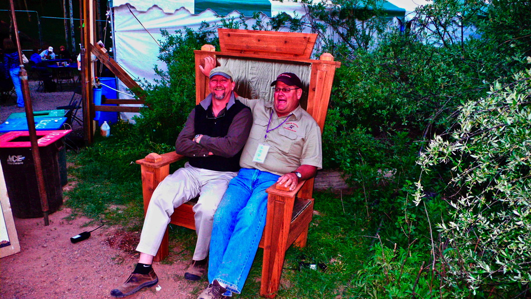 Two men sitting on the throne backstage.